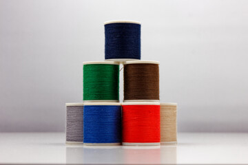 group of sewing spools isolated on white background with real shadows