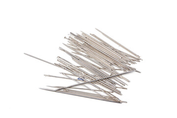 a group of needles on white table