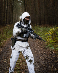 Fototapeta premium Man in a winter camo suit from side narrow shot.