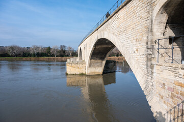 Naklejka premium Avignon, Vaucluse, France - Side view over the historical Saint Benezet bridge and the River Lez