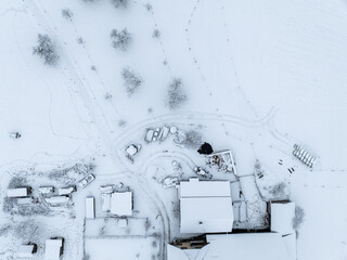 Aerial view of town with snow covered houses. Roof tops with snow on residential buildings in Switzerland.