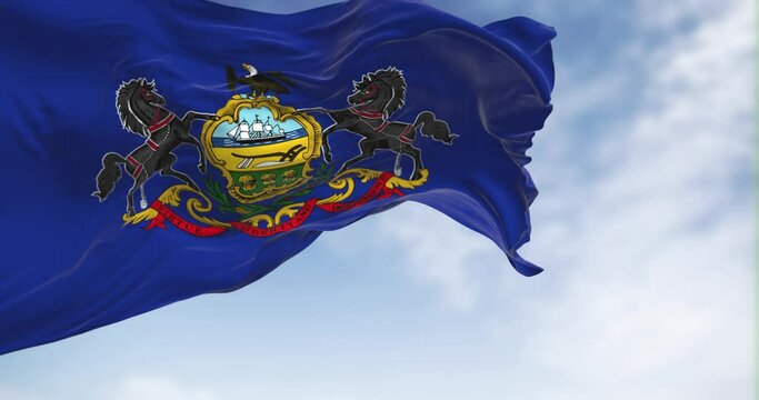Pennsylvania state flag waving in the wind on a clear day.