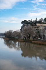 Fototapeta na wymiar Avignon, Vaucluse, France - Fortresses and watch towers at the Saint Benezet bridge and the river Rhone