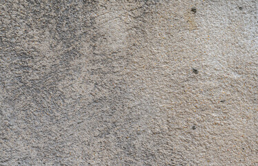 Textured dirty concrete wall of a house in old town, France