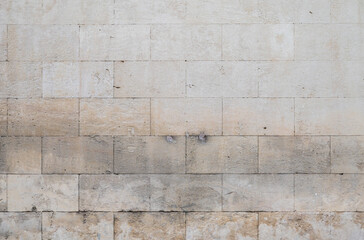 Rough brick stone wall of an historical building in old town, France