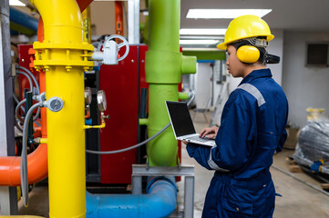 Maintenance technician at a heating plant,Petrochemical workers supervise the operation of gas and oil pipelines in the factory,Engineers put hearing protector At room with many pipes