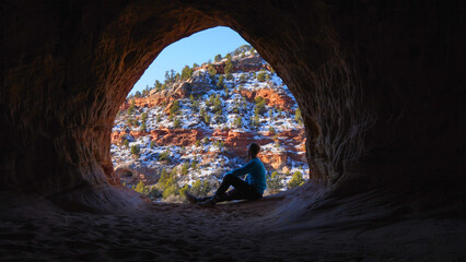 Hiker in a cave in Kanab, Utah