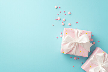 Fototapeta na wymiar Saint Valentine's Day concept. Top view photo of light pink gift boxes with white ribbon bows and heart shaped sprinkles on isolated pastel blue background with copyspace