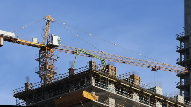Construction site. Skyscrapper building and cranes.