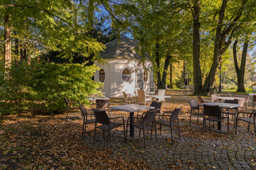 Wicker table and chairs in a park in Pszczyna. Poland.