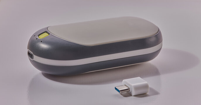 Rechargeable hand warmer shot on a white surface.