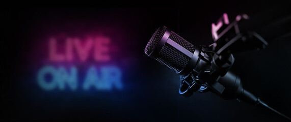live on air. radio podcast broadcasting studio microphone with neon lights sign. banner with copy space