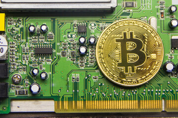 Cryptocurrency bitcoin lies on a microcircuit close-up