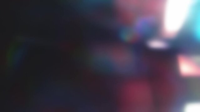 Blurred holographic background with iridescent tints in 4k. Abstract light modulations for overlay effect. Stock video with abstract glow. Gray background with crystal folds and space for text.