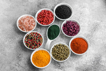 Composition consisting of a variation of several types of spices in white bowls