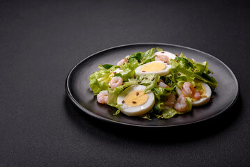 Delicious fresh healthy salad with shrimp, egg, lettuce and flax seeds