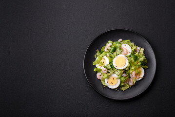 Delicious fresh healthy salad with shrimp, egg, lettuce and flax seeds