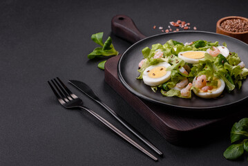 Delicious fresh healthy salad with shrimp, egg, lettuce and flax seeds