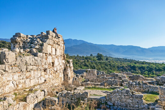 Mother with kids looking at acropolis of Xanthos ancient city - part of Lycian way. Largest city of Lycia. Popular travel destination in Antalya Turkey