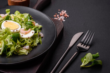 Delicious fresh healthy salad with shrimp, egg, lettuce and flax seeds