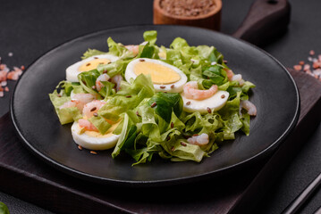 Delicious fresh healthy salad with shrimp, egg, lettuce and flax seeds