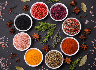 Composition consisting of a variation of several types of spices in white bowls