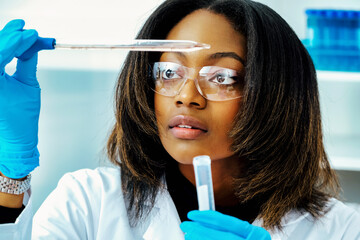close up female scientist looking at test tube