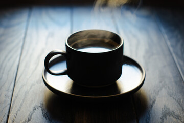 Coffee cup silhouette in back lit, soft focus close-up