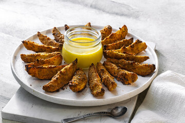 Homemade baked potatoes with parmesan and garlic, oregano and cheese sauce