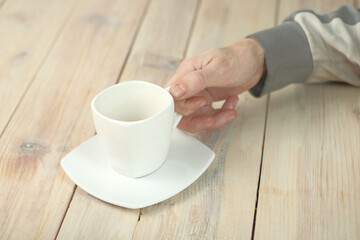 a person holding an empty cup in his hand