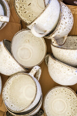 Handmade artisanal ceramic cups with brown dots