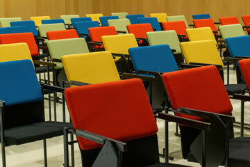 Straight rows of colourful chairs in the hall