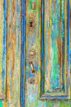 Keyhole On An Old Door Covered With Many Layers Of Colorful Paint