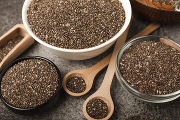 Chia seeds in a bowl and spoons on black marble. Superfood. Antioxidant. Healthy food. Proper nutrition. Diet concept. Place for text. Place to copy.