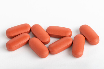 Pile of medical pills on white background