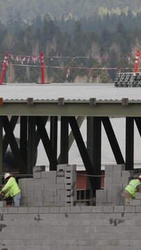 Vertical Video Construction Workers Build Wall Timelapse