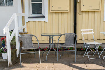Chairs and table for relaxing outdoors on the terrace, veranda. Comfort relaxing zone. Cozy and comfortable atmosphere. Sunny day.