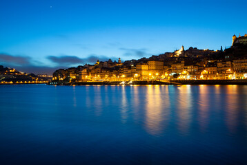 Skyline of Porto in Portugal illuminated at dusk over the River Douro
