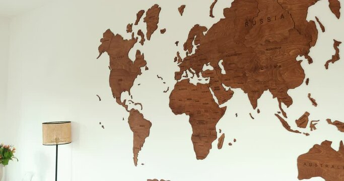 Elegant wooden world map modern room white wall, wall decoration . High quality 4k footage