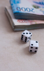 Dice on the background of money