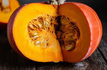 Cut pumpkin on a wooden table. Cooking in the kitchen.