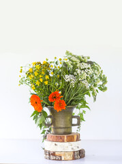 Medicinal herbs. Bright summer flowers in brass mortar.