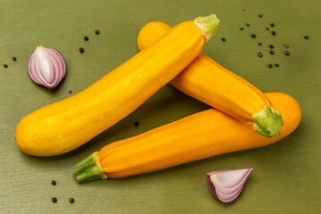 Yellow zucchini and blue onion halves, allspice.