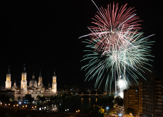 Fototapeta premium Firework with cityscape night light view of river side Zaragoza skyline