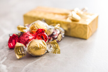 Sweet candy wrapped in foil on kitchen table.