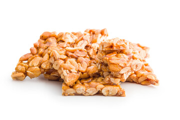 Sweet peanut brittle. Tasty peanuts in caramel isolated on white background.