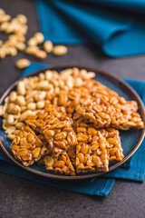 Sweet peanut brittle. Tasty peanuts in caramel on plate.