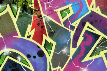 Colorful background of graffiti painting artwork with bright aerosol strips on metal wall. Old...