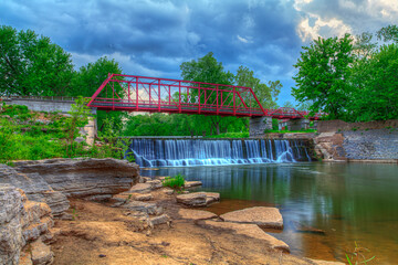 Red three span truss bridge crossing Apple Creek 