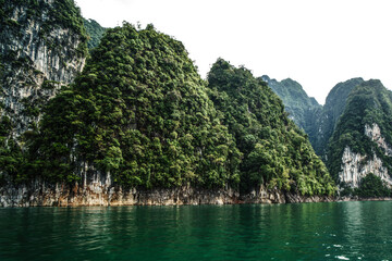 Fototapeta na wymiar View of tropical limestone mountains in Thailand .Scenic landscape of the lake in Khao Sok National Park.